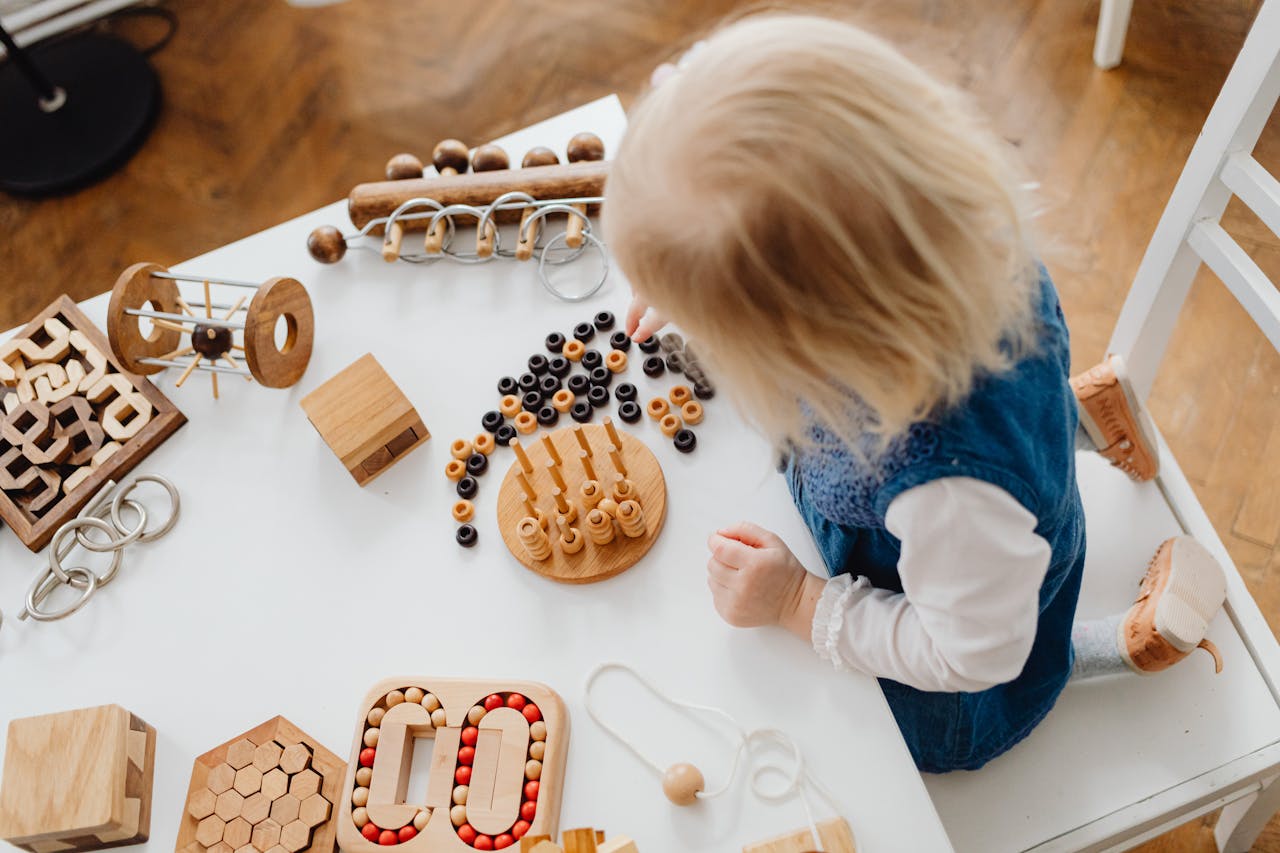 A child engaged in learning with wooden toys at a table, perfect for early education themes.